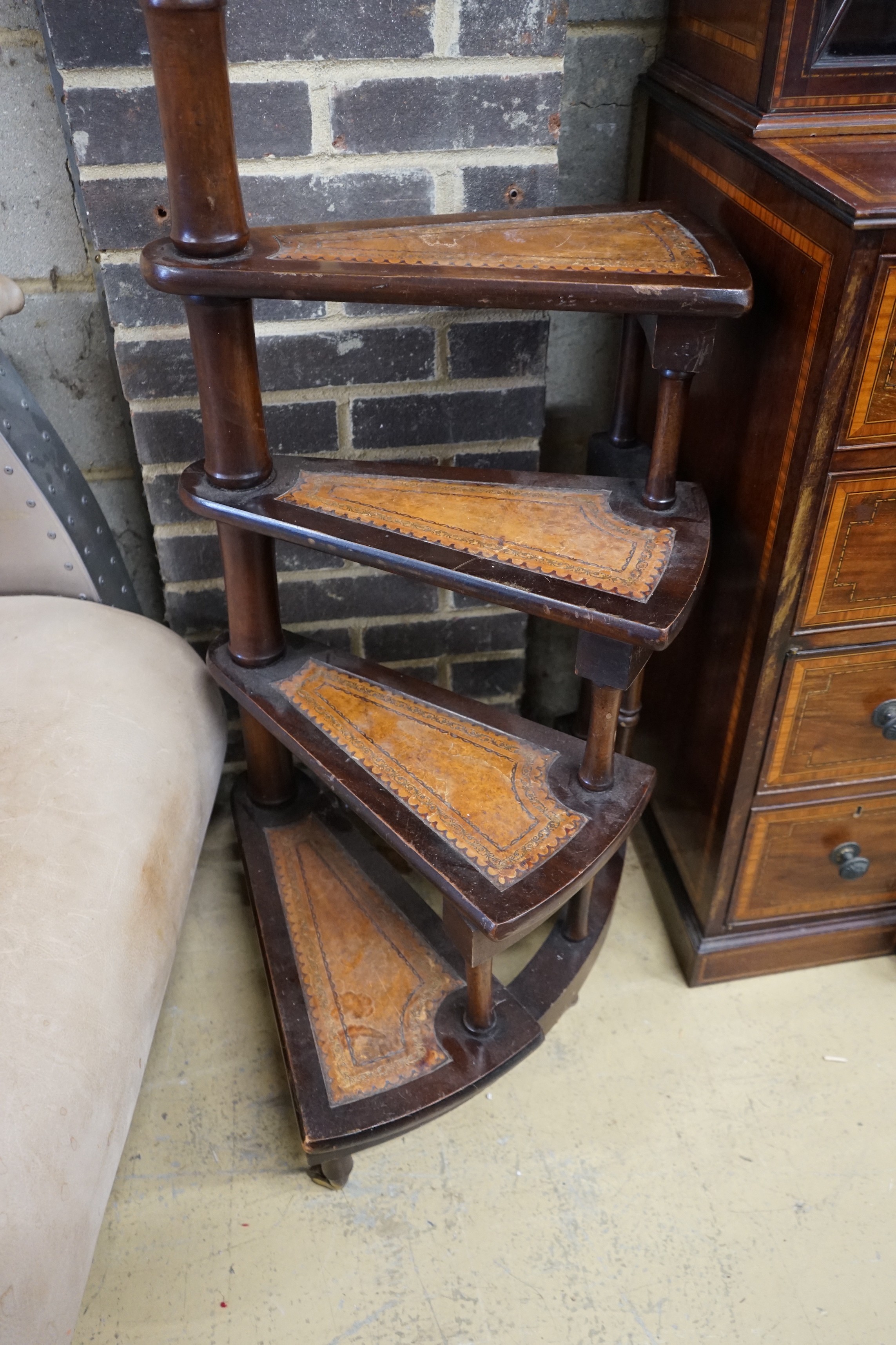 A set of reproduction Victorian style mahogany four tread library steps on brass castors, height 170cm